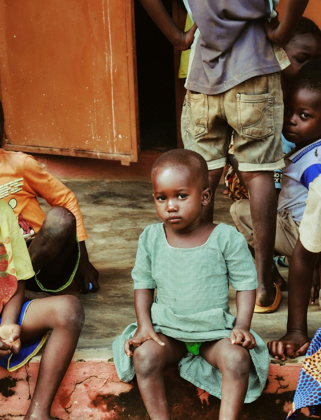 Children sitting in a doorway in a Keta lagoon community